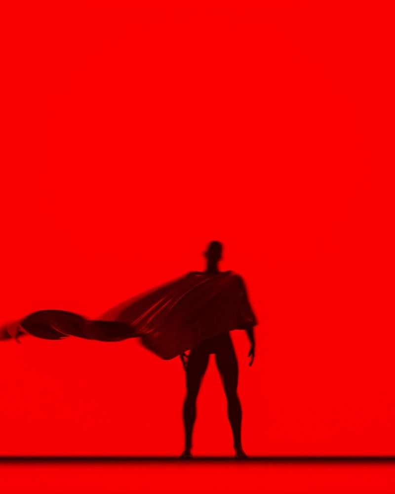 Person performing a dynamic, flowing movement in a bright, spacious room.